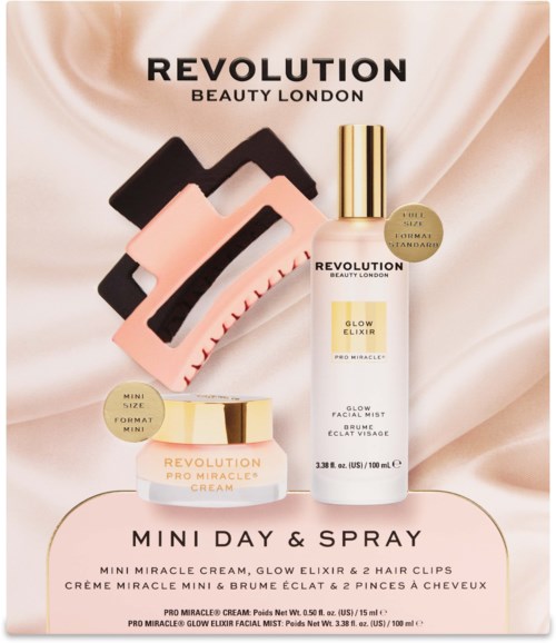 Revolution Beauty London-logo med mini miraclekrem, glow elixir och två hårklips på ett mjukt satins bakgrund.