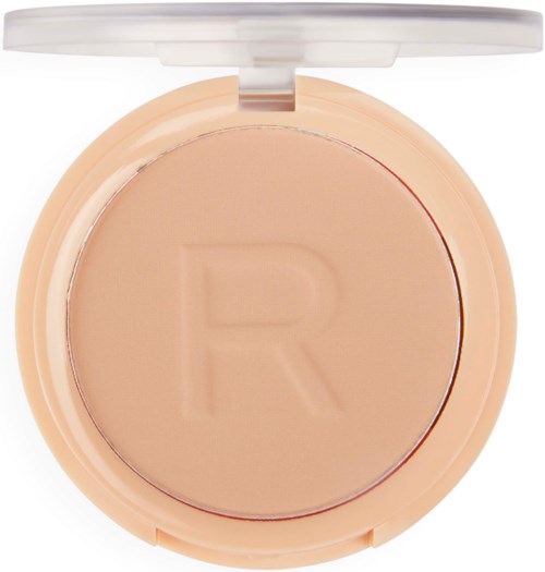 Compact makeup powder with a round shape, light beige color, and a letter 'R' embossed on the surface.