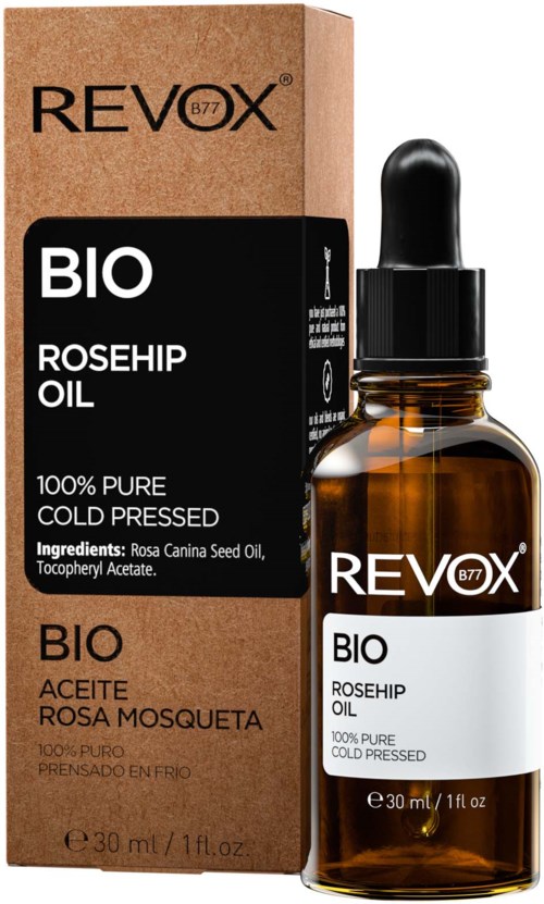 Pieni ruskea pullo tiputulpalla, vierekkäin kartonkivalko, jossa lukee "Revox BIO Rosehip Oil."