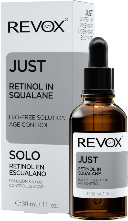 Een bruin glazen fles met een zwarte druppelaar, gelabeld 'Revox Just Retinol in Squalane' en zijn doos.