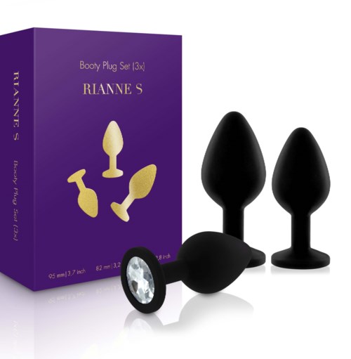 Eine Schachtel mit Erwachsenen-Spielzeug, zwei schwarze Buttplugs und einer mit einem Stein, in violettem Verpackung.