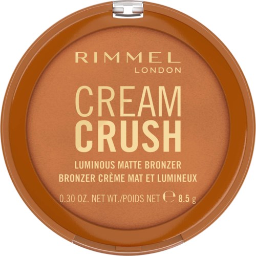 Rimmel London Cream Crush hehkuva matta bronzerin ympyrämäisessä pakkauksessa, läpinäkyvä kansi, hiekanvärinen tuote sisällä.