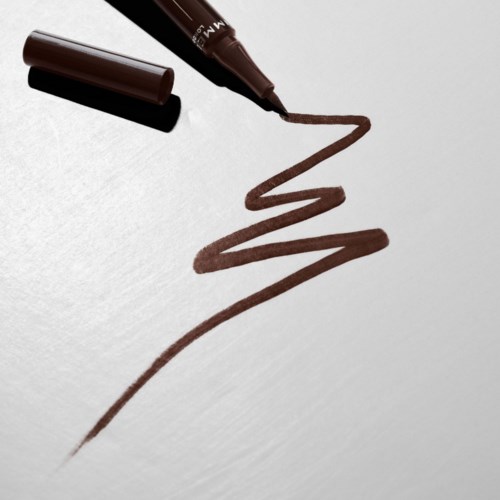 Brown marker drawing zigzag lines on a white surface. Marker lid is off.
