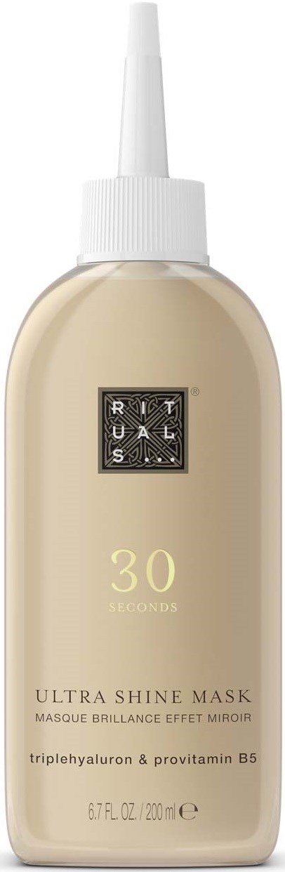 A bottle of skincare product called Ultra Shine Mask, with a white cap and beige liquid inside.