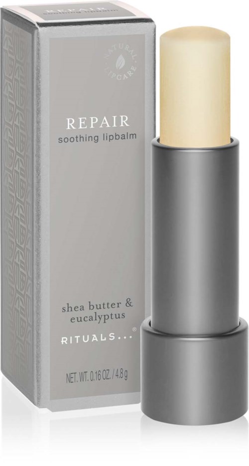 A lip balm stick with shea butter and eucalyptus, in a silver container, next to its box.