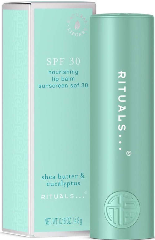 A green tube and box of lip balm with SPF 30, shea butter, and eucalyptus. The brand is Rituals.