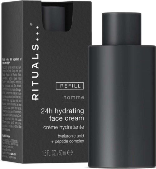 En svart boksmerket Rituals refill ansiktskrem med en svart flaske ved siden av.