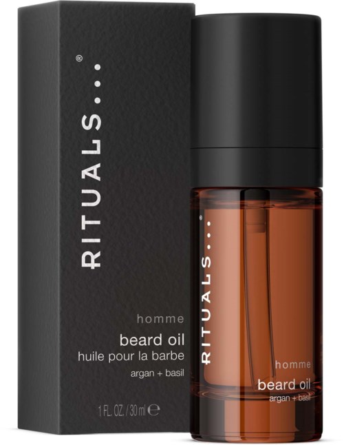 Eine Bartölflasche neben ihrer schwarzen Verpackung, beschriftet 'RITUALS' und 'hombre beard oil, argan + basil.'