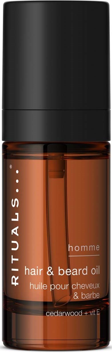 En liten brun flaske med svart kork merket Rituals hår- og skjeggolje, inneholder sedertre og vitamin E.