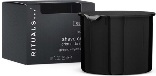 En svart behållare med rakkräm och en svart låda bakom, märkt RITUALS och beskriver produkten.
