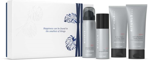 A set of skincare products in white and gray bottles with black caps, placed in front of a white box. The box has blue leaves and a quote.