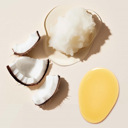 Coconut oil, coconut pieces, and coconut pulp on a white surface.