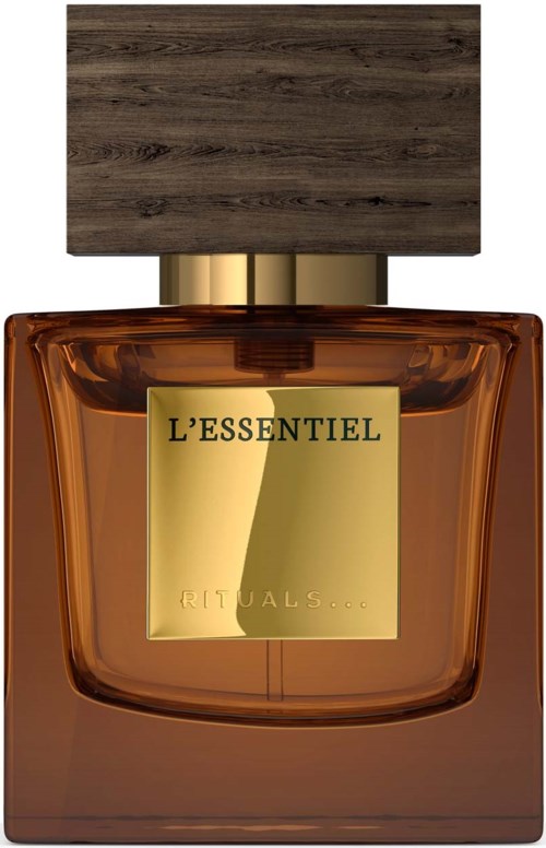 En parfyllflaska med ett trälock och en brunt glas, märkt 'L'ESSENTIEL' och 'RITUALS...'.