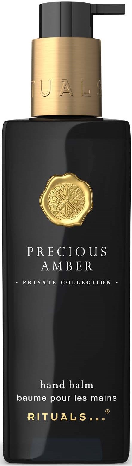 En svart flaske med gullhette og etikett, med håndkrem fra Precious Amber-serien.