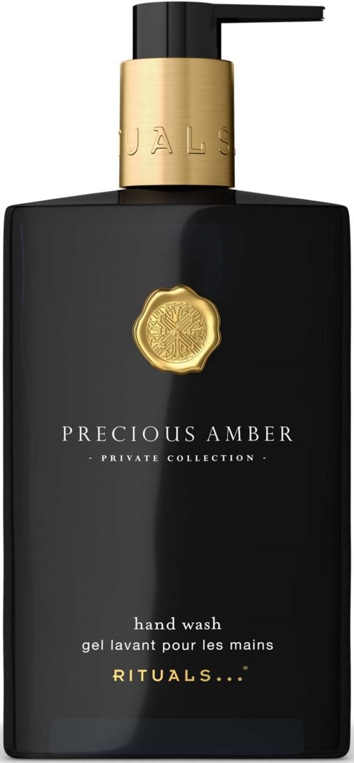 Svart håndvasksflaske med gullfarge pump og etikett, med teksten Precious Amber, Private Collection og Rituals.
