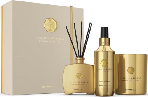 Lyxig guldfärgad hudvårdsset med box, diffuser, sprayflaska och burk, alla med Rituals-varumärket.