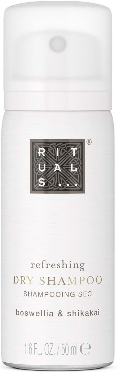 White bottle with black text, labeled "Refreshingly Dry Shampoo" and ingredients boswellia and shikakai.