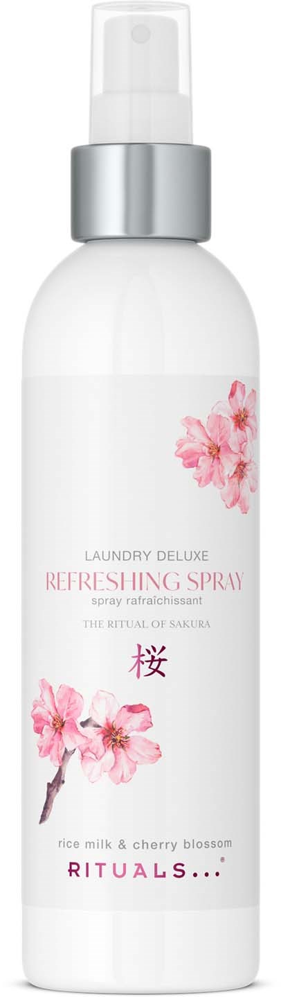 A white spray bottle with pink cherry blossom flowers, labeled 'Laundry Deluxe Refreshing Spray' and 'Rituals'.