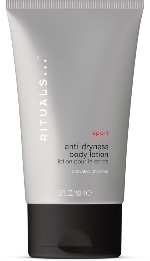 Eine graue Tube mit RITUALS Anti-Trockenheit-Bodylotion mit schwarzem Deckel, für Sport, mit aktiviertem Kohl.