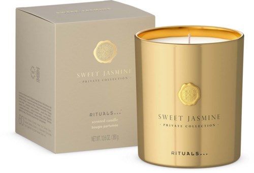 Eine goldene Kerze in einem glänzenden Behälter mit einer Box mit der Aufschrift 'Sweet Jasmine'.