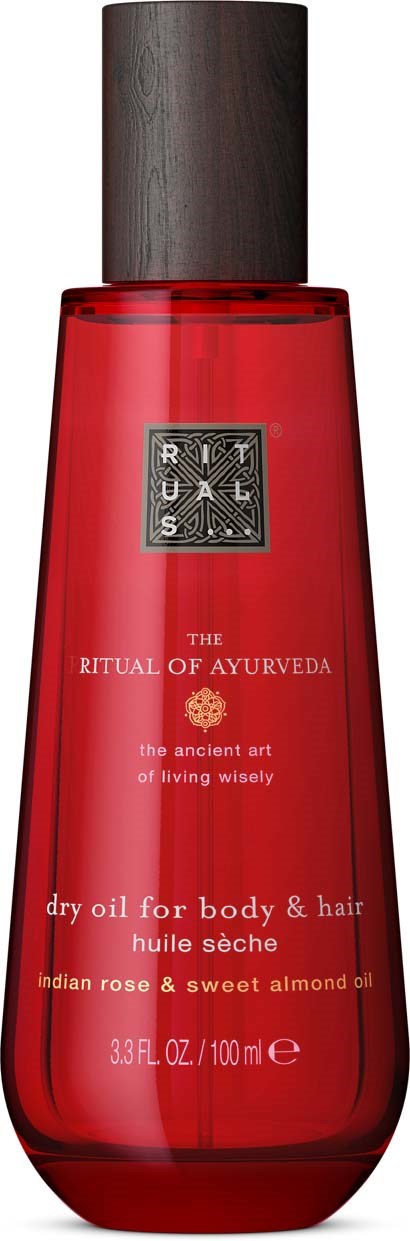 A red bottle with a dark cap, labeled as dry oil for body and hair, containing Indian rose and sweet almond oil.