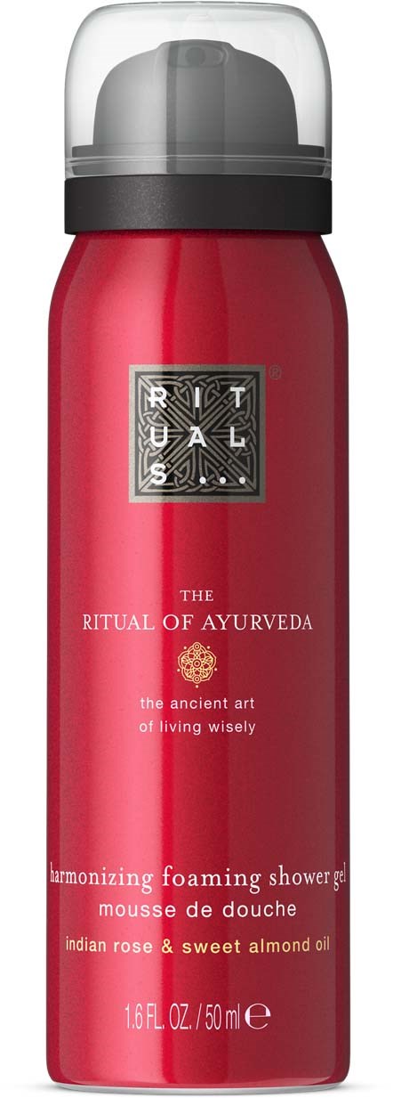 A red foaming shower product with black and silver label, branding as Ritual of Ayurveda with white text and symbols.