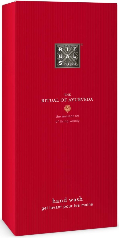 Eine hohe, rote Flasche mit einem silbernen Etikett und weißem Text, die Händewasche nach Ayurveda bewirbt.