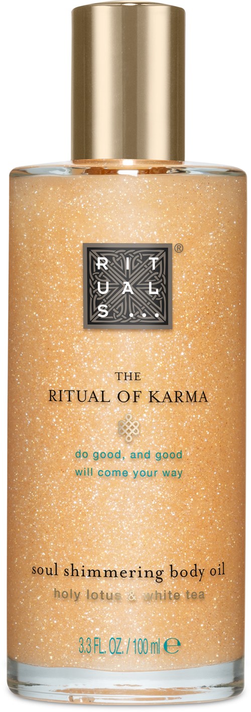 Pitkä pullo vartaloöljyä, nimi 'The Ritual of Karma', kultainen korkki, hohtava kullanvärinen neste sisällä.