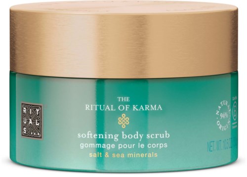 A teal jar with a gold lid, labeled 'The Ritual of Karma' body scrub with salt and sea minerals.
