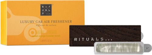 A luxury car air freshener with a black cloth holder and silver metallic clip in front of an orange box.