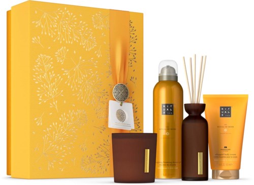 A set of home fragrance products with yellow packaging, a diffuser bottle, reed sticks, and a boxed gift set.