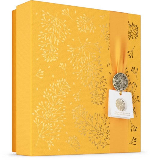 A yellow gift box with white leaf patterns and a ribbon with a silver medal attached.