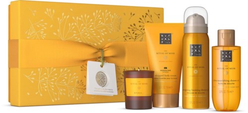 A yellow skincare gift set with creams, lotion, and a box tied with a yellow ribbon.
