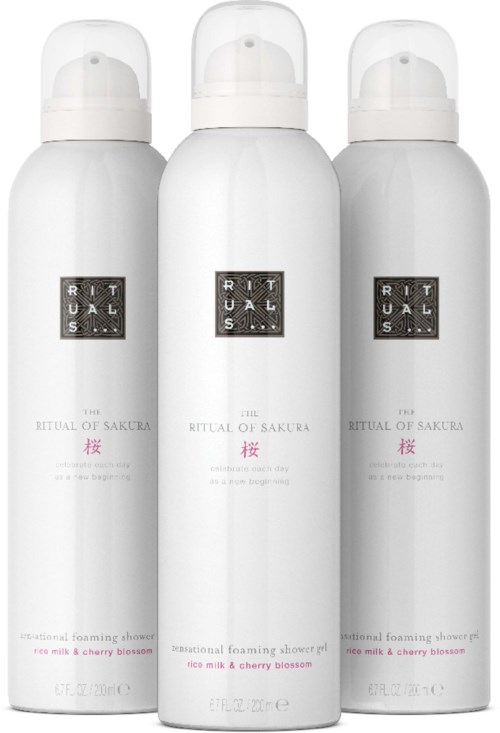Three white bottles labeled Ritual of Sakura, with pink cherry blossom text, arranged side by side.