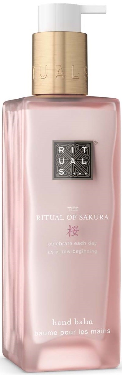 En rosa håndkrem i en lang, rektangulær flaske med hvit pumpe og gullhette, merket The Ritual of Sakura.