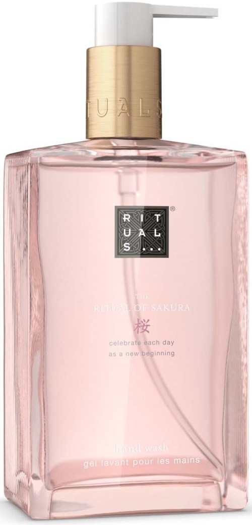 Eine rosa Flüssigseifenspender mit weißen Pumpen und goldenem Band. Das Etikett zeigt Marke und Text.