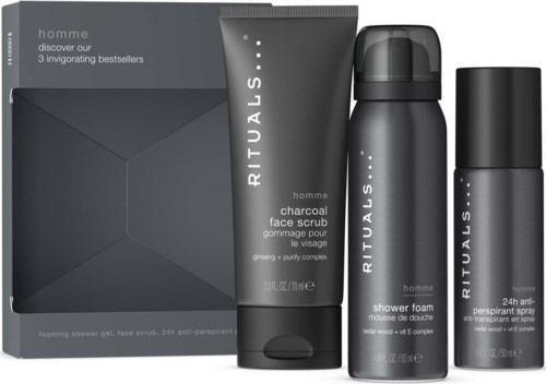 Graue Box mit drei Rituals-Herrenausrüstungsprodukten: Gesichtspeeling, Duschschaum und Deo-Spray.