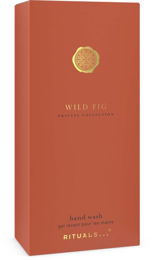 En høy, oransje eske med en gullmerke øverst og ordene Wild Fig håndvask.
