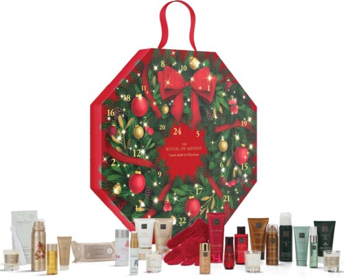A red and green Advent calendar shaped like a wreath with 24 numbered doors, surrounded by various skincare products.