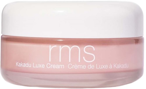 Eine rosa Dose mit rms Kakadu Luxe Cream und weißem Deckel, beschriftet mit weißem Text.
