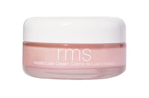 Ett rosa krämglas med vit lock, märkt 'rms Kakadu Luxe Cream'.