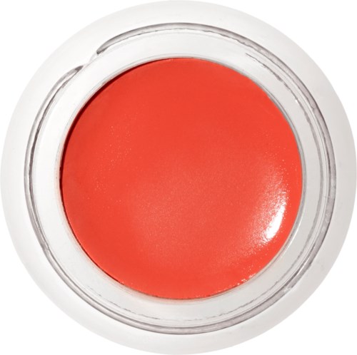En rund behållare med orangefärgad läppstift eller glans inuti.