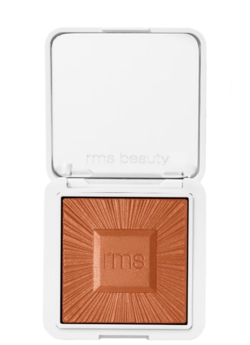 Ein Make-up-Kompakt mit warm orangener brauner gepresster Puder.
