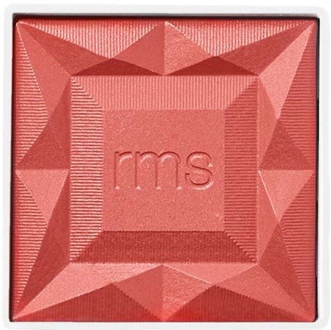 Rote Kosmetikdose mit den Buchstaben 'rms' in der Mitte und dekorativen geometrischen Mustern.