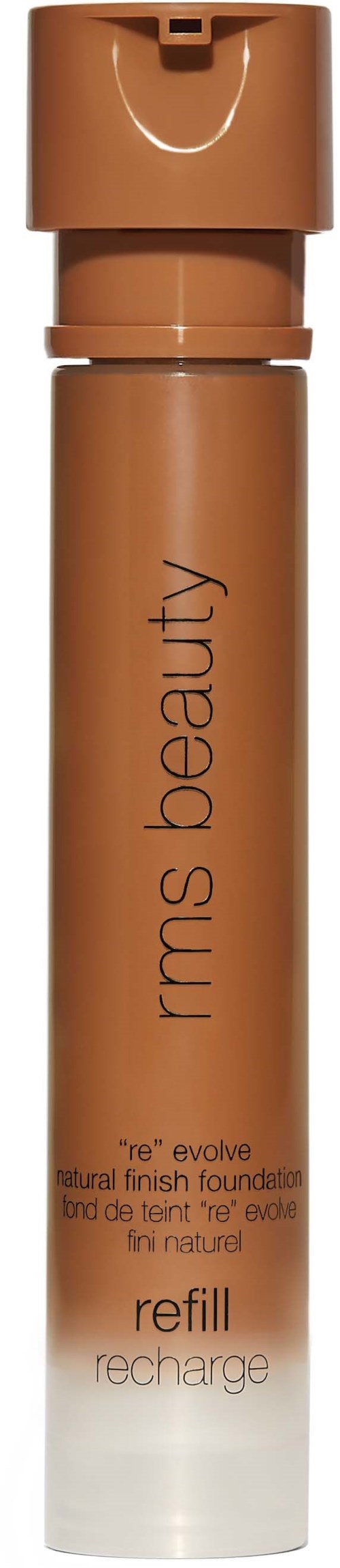 Eine Tube KMS Beauty Foundation Nachfüllung mit braunem Deckel und Körper, beschriftet 're evolve' und 'refill'.
