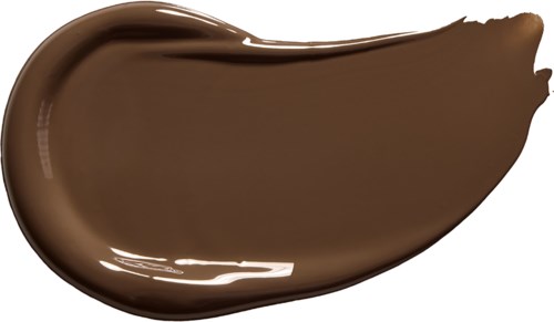 Ein Klecks cremiger, glänzender brauner Substanz, geformt wie eine Träne oder längliches Oval.