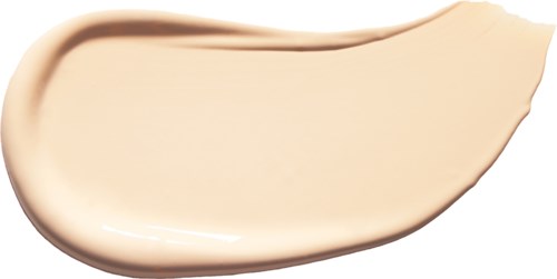 Eine cremig-beige Flüssigkeit gleichmäßig verteilt, mit einem runden Rand auf einer Seite und einer gerippten Kante auf der anderen.