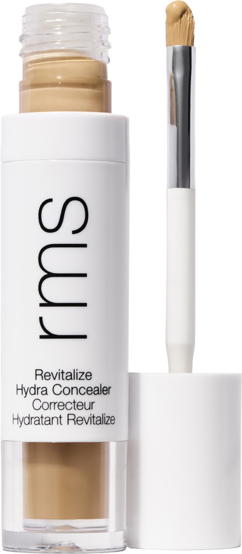 Ein weißer Behälter mit beigefarbener Abdeckung und Applikatorpinsel, beschriftet 'rms Revitalize Hydra Concealer'.