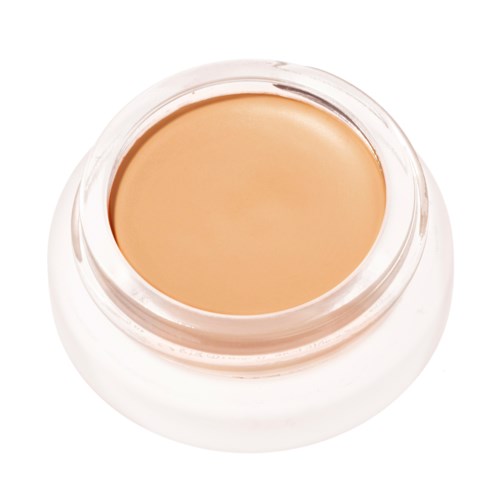 Ein kleiner Behälter mit beige Foundation oder Creme ohne sichtbares Etikett.