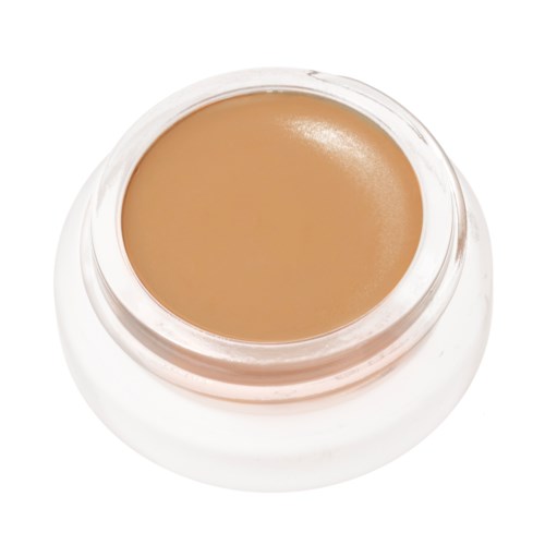 A small jar of beige-colored cream or foundation, with the top visible and the product inside.